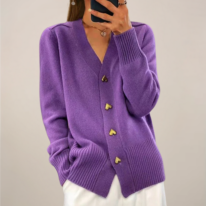 Versatile purple women's cardigan featuring elegant gold heart buttons. Relaxed fit, ideal for chic all-season wear.