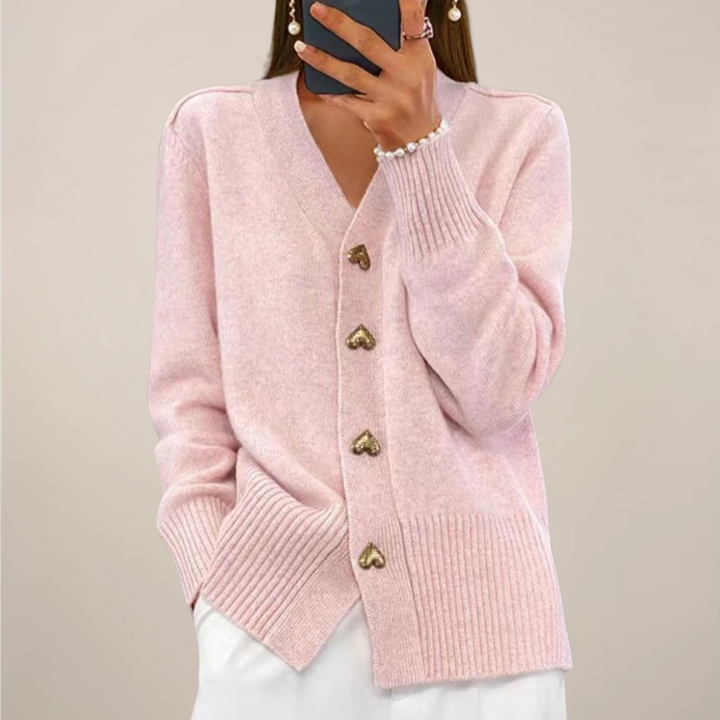 Soft pink women's cardigan with relaxed fit and elegant gold heart buttons, a cozy long sleeve layering piece.