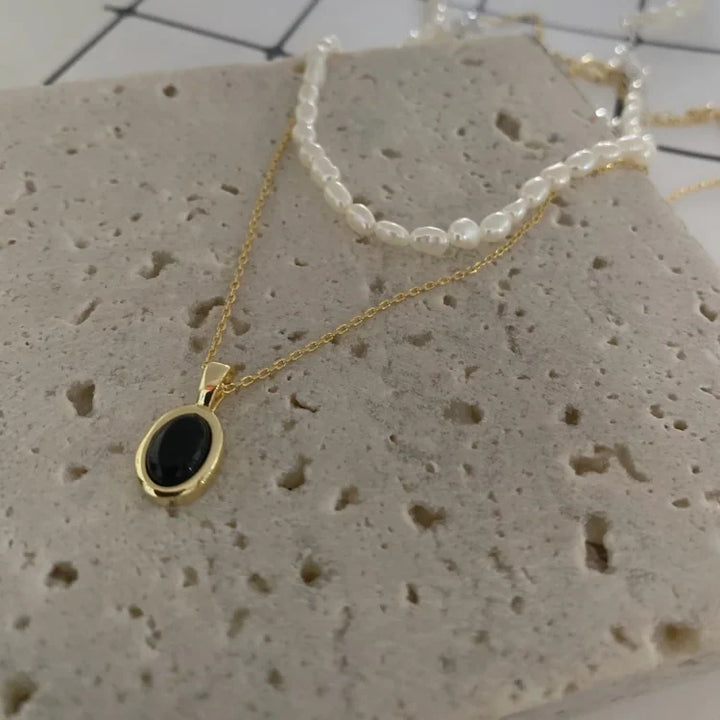 Elegant women's black onyx and pearl layered necklace set, a fashionable two-piece jewelry ensemble.