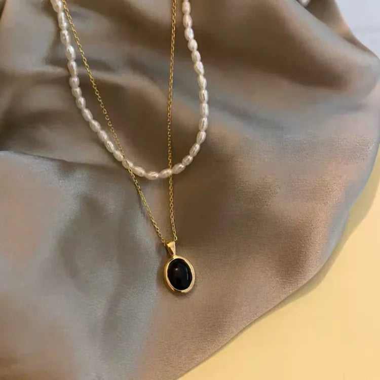 Stylish women's black onyx and freshwater pearl layered necklace, chic fashion jewelry.