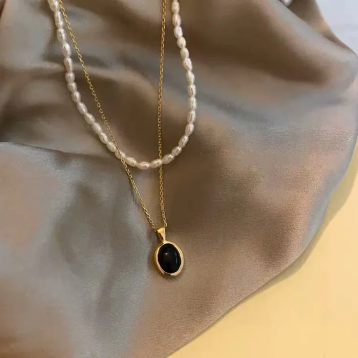 Stylish women's black onyx and freshwater pearl layered necklace, chic fashion jewelry.
