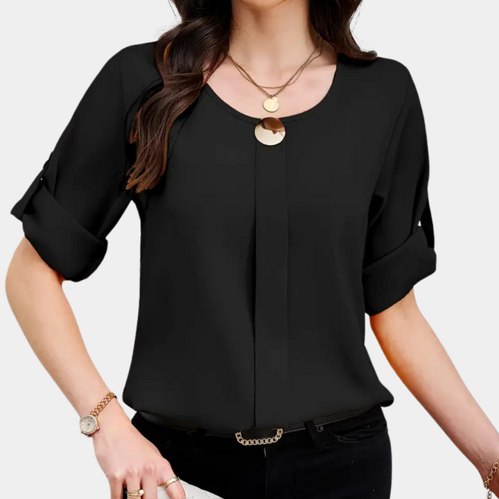 Chic black pleated top for women, versatile for office or casual outfits. Features elegant pleats and a comfortable loose fit.
