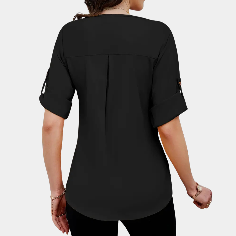 Fashionable women's black blouse featuring elegant pleats, long sleeves, and a loose fit for a chic, versatile look.