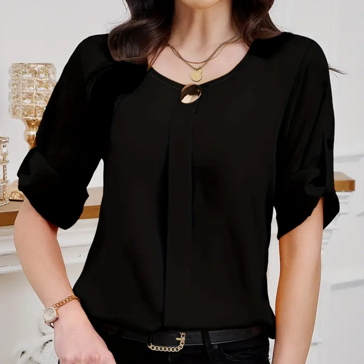 Sophisticated women's black pleated blouse, ideal for office or elegant casual wear. Long-sleeve, loose fit top for chic style.