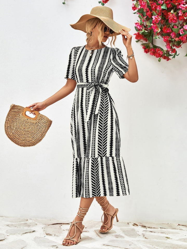 Effortless style with this women's black & white striped midi dress, a chic short-sleeve summer staple.
