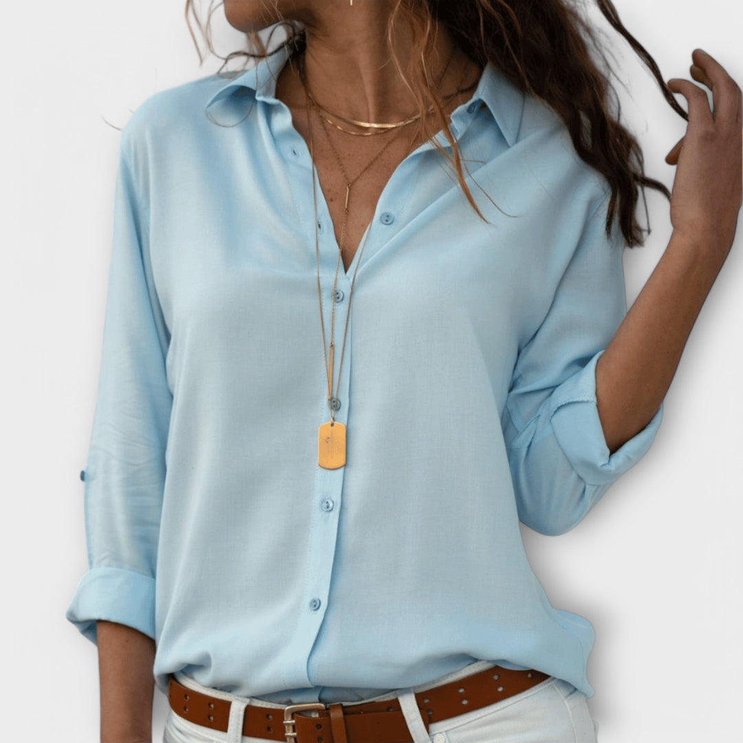 Stylish women's blouse in a classic design. Elegant top for versatile office & evening wear.