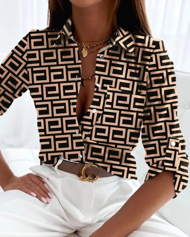 Women's elegant blouse featuring a unique geometric artistic print. Versatile long sleeve top for a chic look.