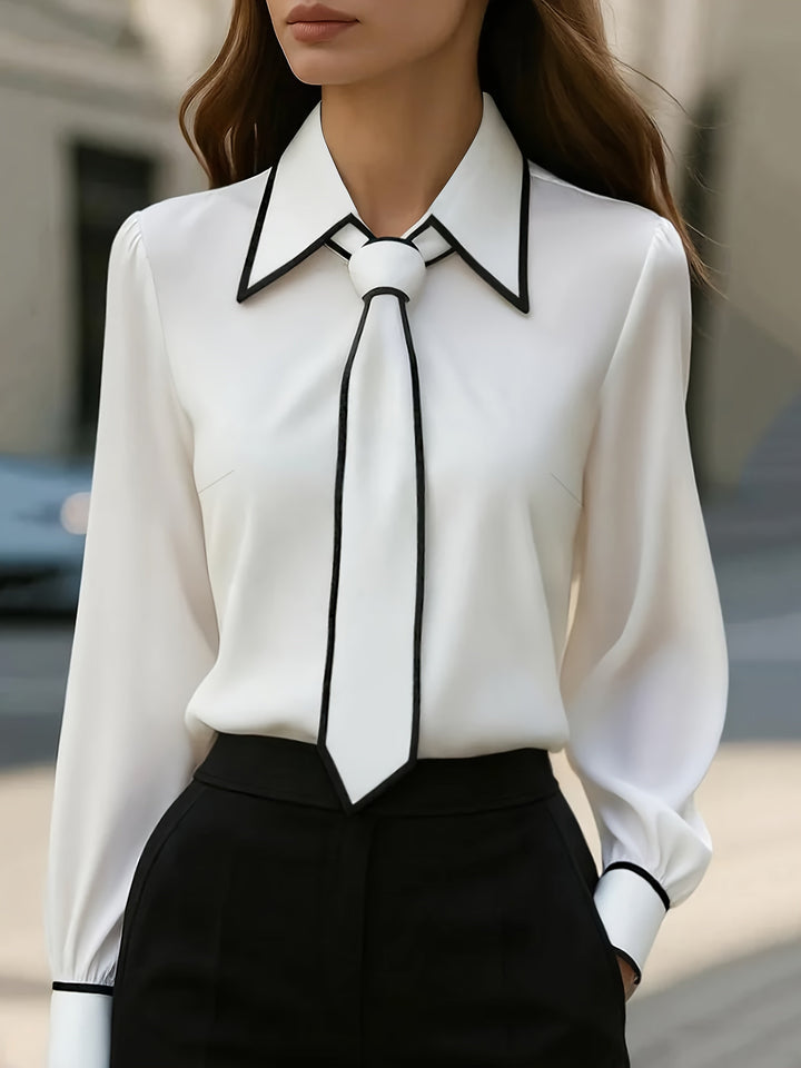 Elegant women's blouse with contrast trim & tie neck. Perfect for office or smart casual. Long sleeve, versatile.