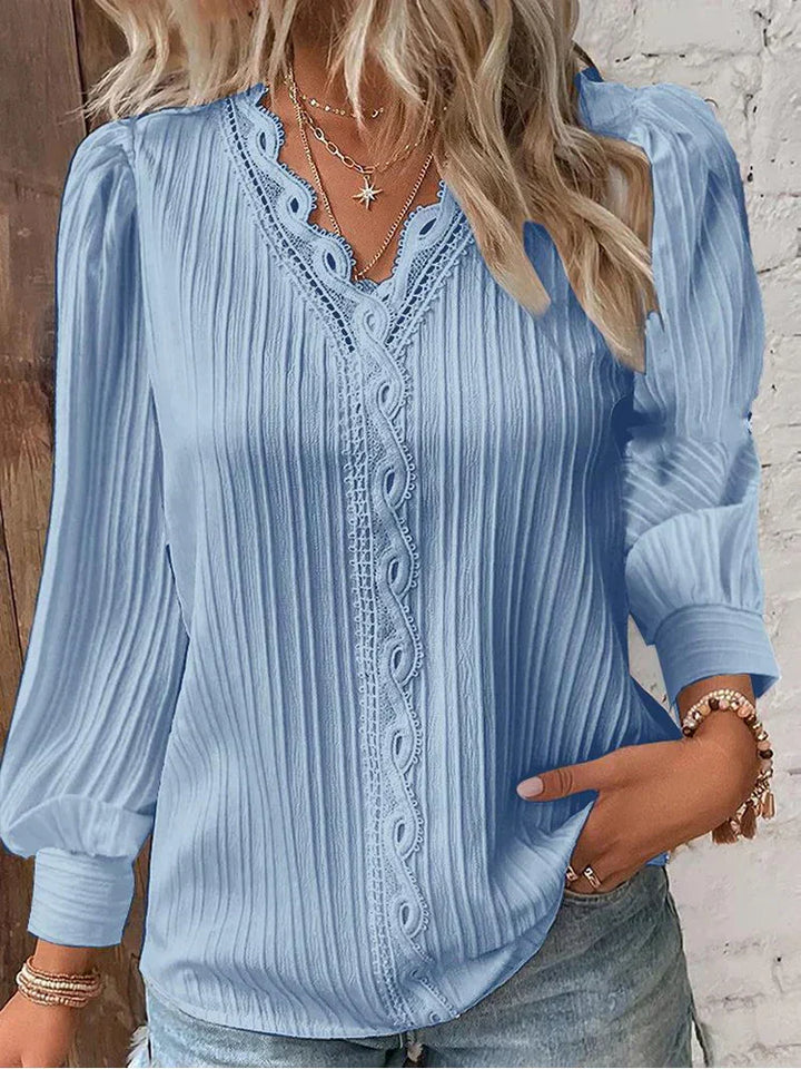 Chic women's relaxed fit blouse with delicate lace details, a versatile top for casual or elegant wear.