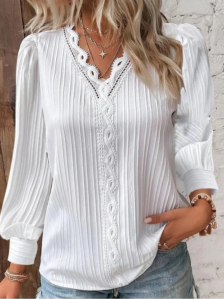 Women's elegant blouse featuring delicate lace and stylish puff sleeves, a perfect spring/summer fashion top.