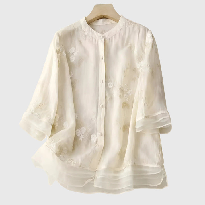 Elegant women's blouse with intricate floral embroidery, featuring a comfortable relaxed fit for stylish casual wear.