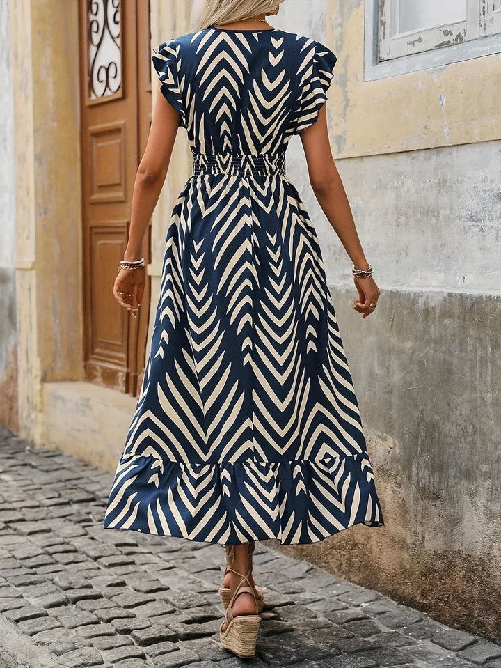 Flattering women's midi dress featuring a unique twisted waist design and vibrant print.