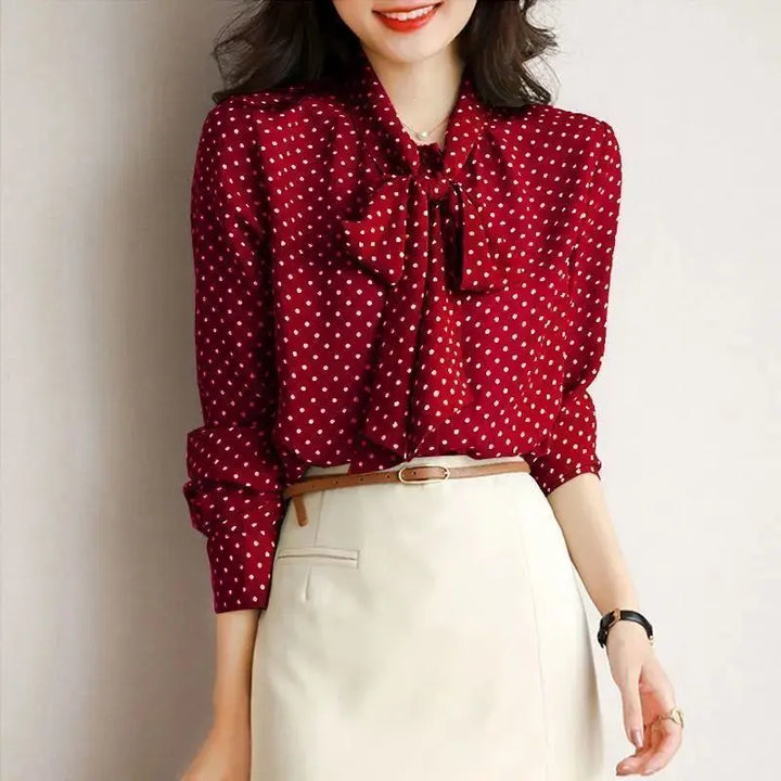 Black elegant women's blouse with bow and shawl collar, a professional and stylish top for office fashion.