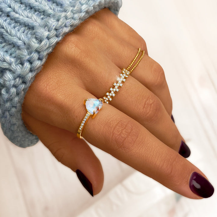 Close-up of a women's braided double ring, combining sterling silver & gold plated intricate design, a stylish accessory.