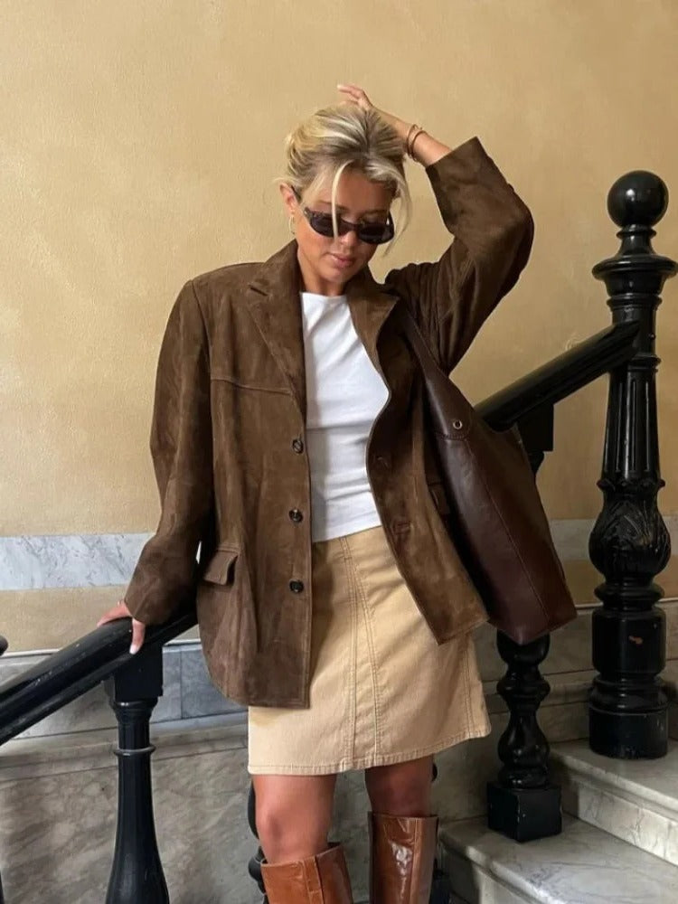 Women's elegant brown long-sleeve suede jacket with pockets, essential autumn apparel for sophisticated layering.