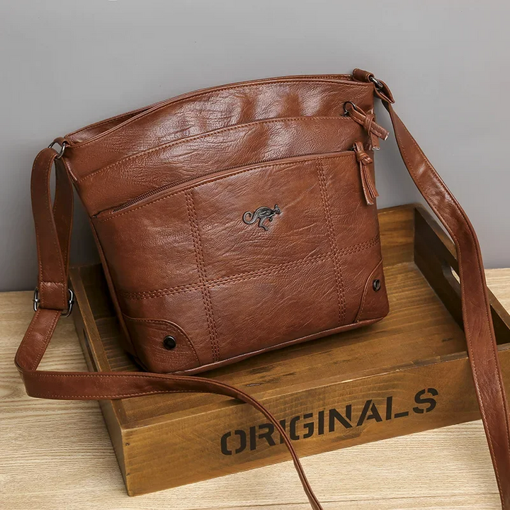 Chic black vegan leather shoulder bag for women. Versatile daily handbag, ideal for office or casual wear.