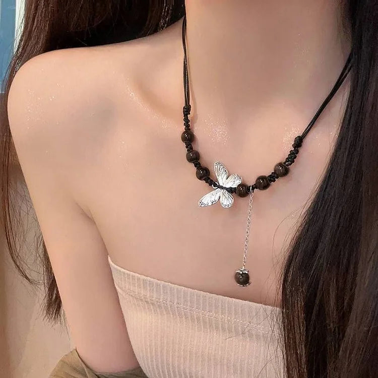 Elegant women's butterfly & pearl necklace. Delicate fashion accessory, versatile gift for her.