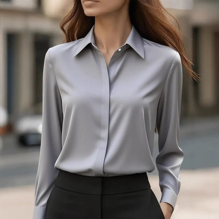 Polished women's long-sleeve button blouse, an elegant top with refined details for work.