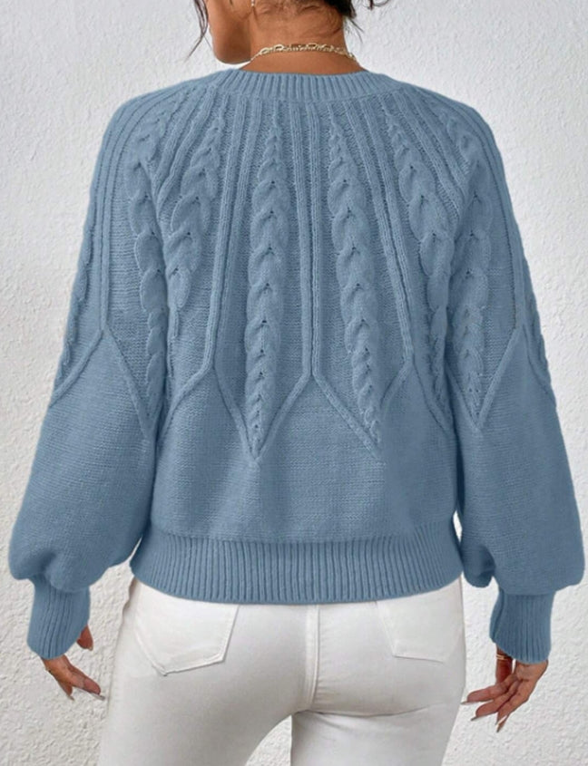 Chic knit top for women, a cozy cable knit sweater with stylish balloon sleeves and ribbed trim.