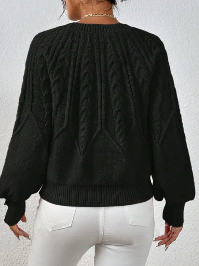 Fashionable women's knit top, an elegant cable knit sweater featuring stylish balloon sleeves.