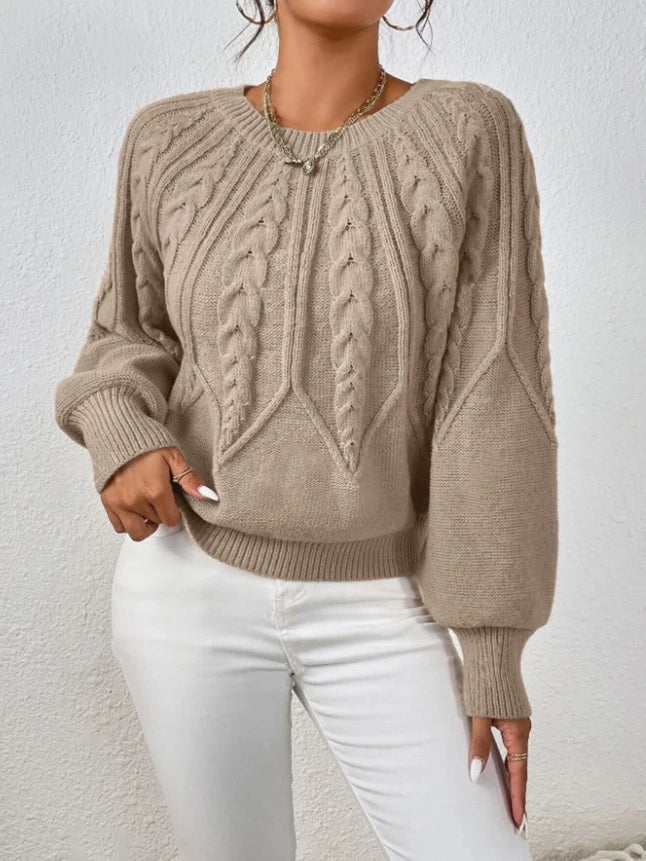 Chic cropped cable knit sweater for women, featuring trendy balloon sleeves and ribbed trim.