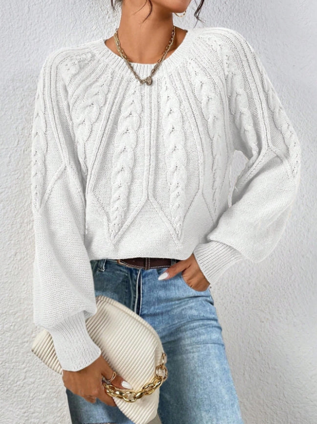 Classic cable knit pattern on a women's elegant sweater with voluminous balloon sleeves.