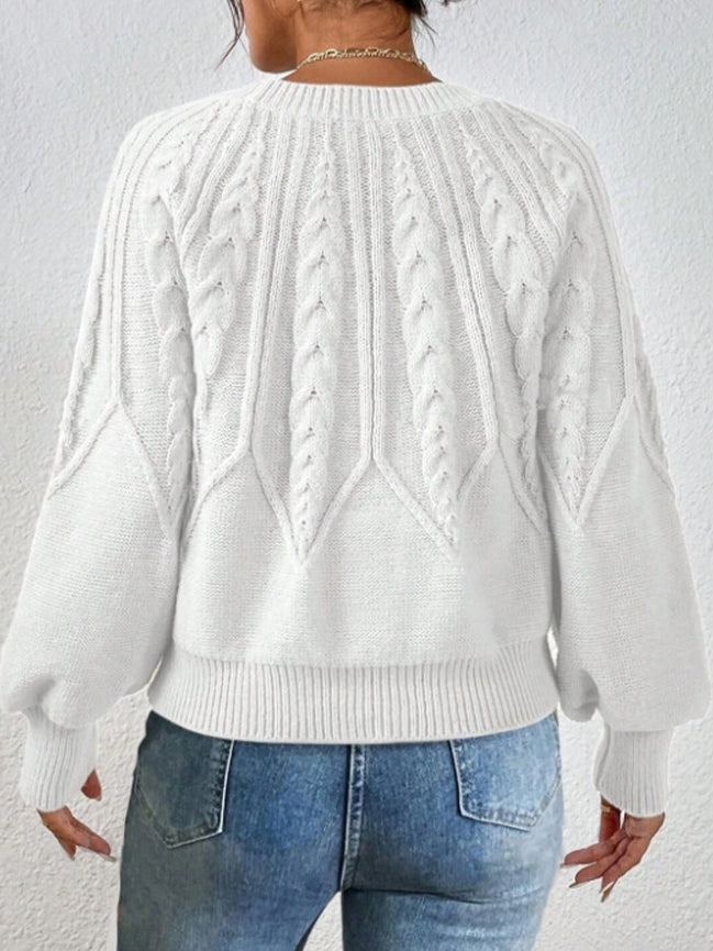 Stylish cropped knit sweater for women, featuring beautiful cable knit and elegant balloon sleeves.