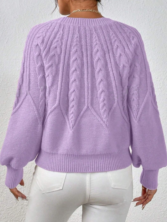 Winter-ready women's cable knit top with balloon sleeves, offering stylish comfort and warmth.