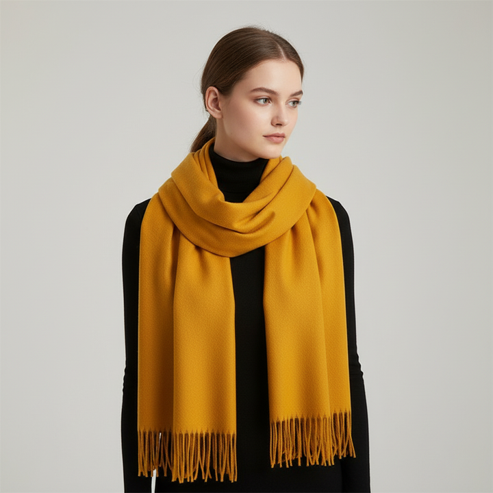 Close-up of a women's soft cashmere blend scarf showing fringed details and rich texture.