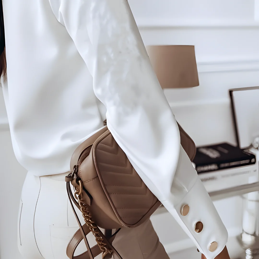 Stylish women's long-sleeve button-down shirt with a classic collar. Versatile for office, casual, or elegant fashion.
