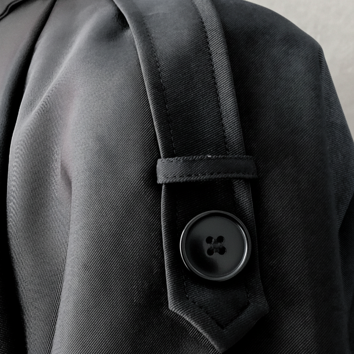 Front view of a women's double-breasted trench coat, showcasing its timeless and elegant style