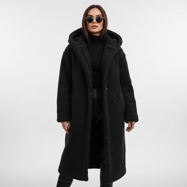 Warm hooded longline coat for women, ideal for autumn wear, featuring a comfortable and elegant design.