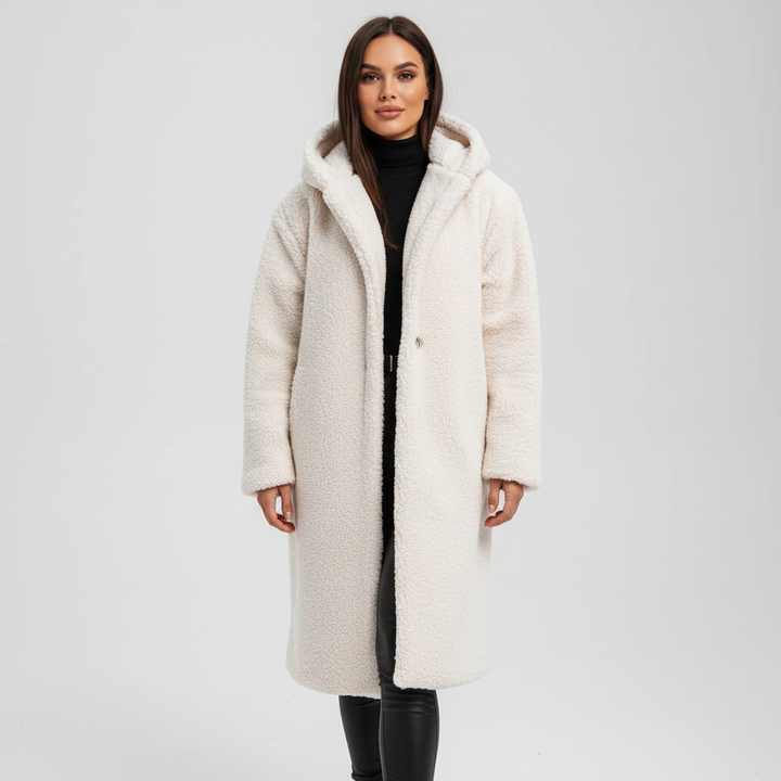 Detail of the hood and collar on a women's elegant and warm longline coat, essential for cold weather.