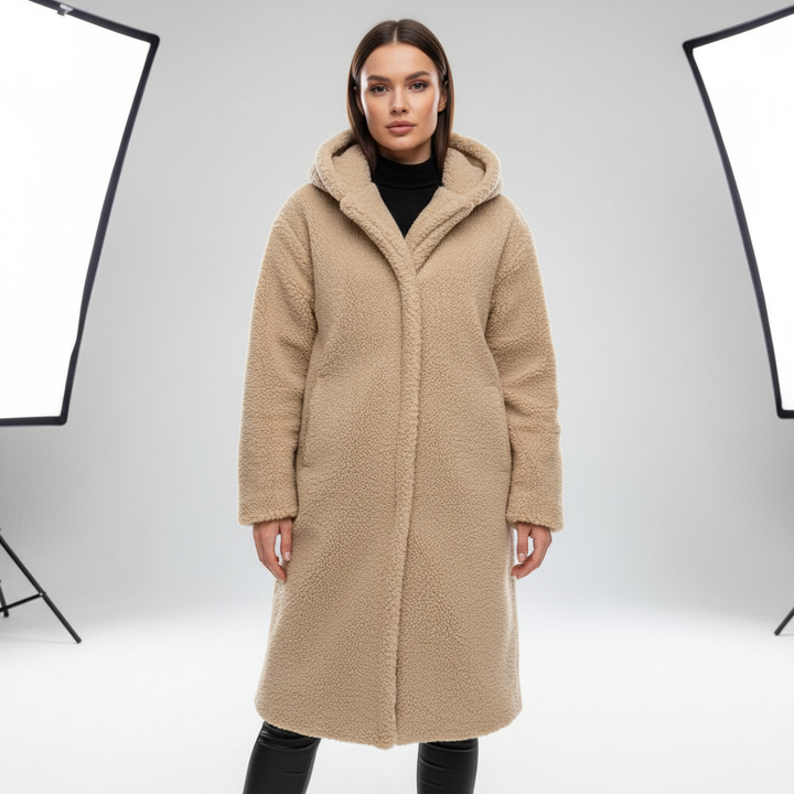 Side profile of the women's cozy autumn longline hooded coat, showcasing its flattering silhouette.