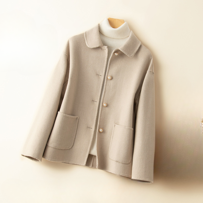 Sophisticated women's cropped jacket, a chic fall fashion piece with an elegant doll collar design.
