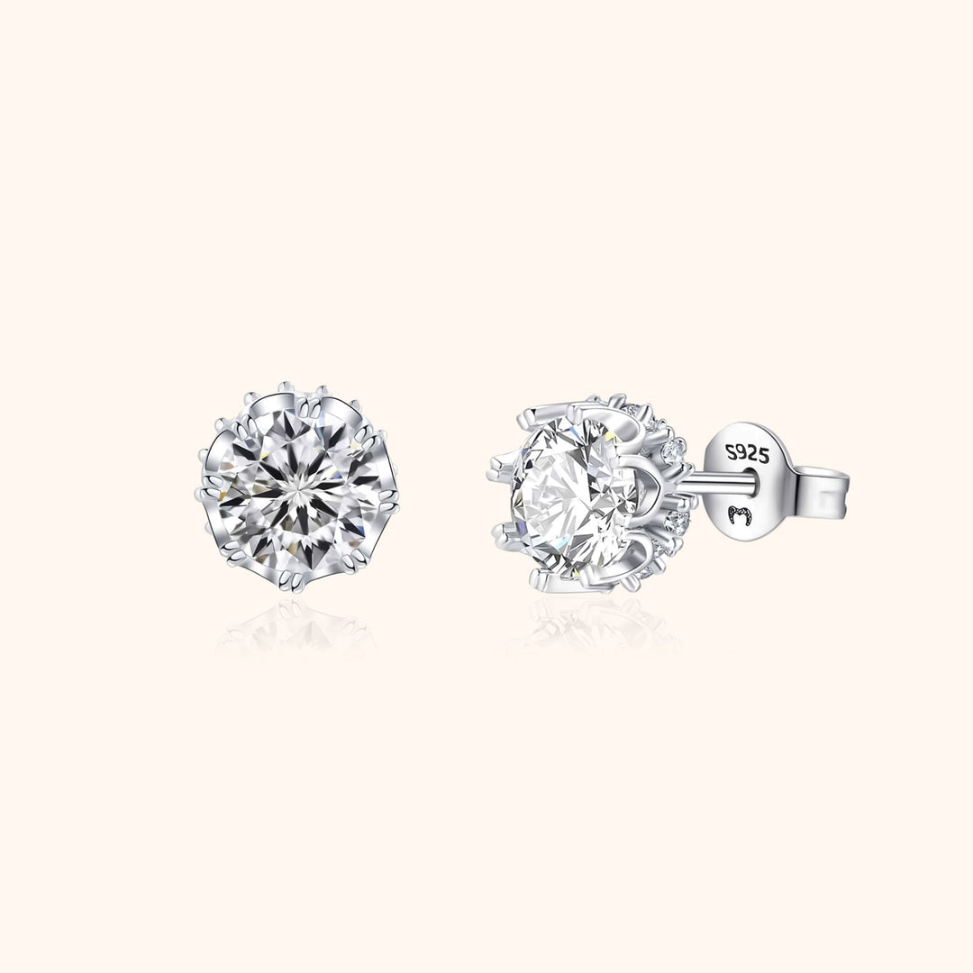 Close-up of elegant women's sterling silver crown stud earrings, gold plated & featuring sparkling zirconia stones.