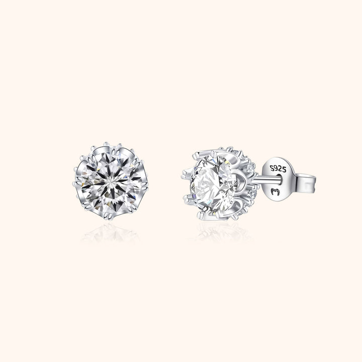 Close-up of elegant women's sterling silver crown stud earrings, gold plated & featuring sparkling zirconia stones.