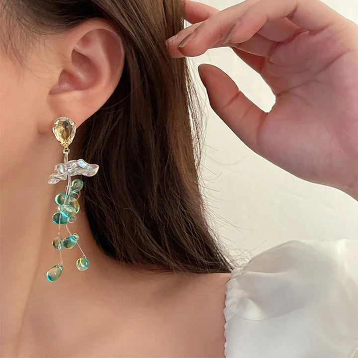 Sparkling crystal flower tassel earrings for women. Elegant fashion jewelry, delicate and perfect for special occasions.