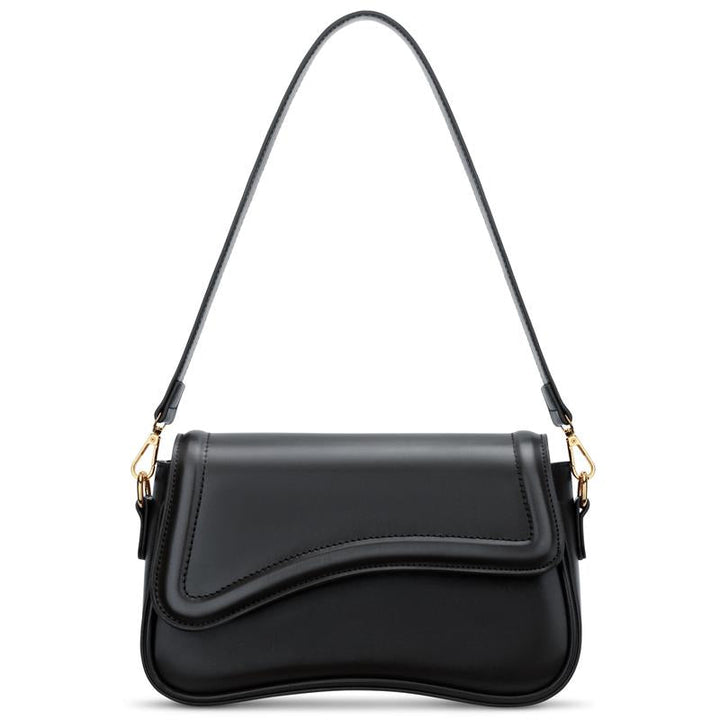 Elegant women's curved flap shoulder bag in vegan leather. Chic minimalist handbag for fashion.