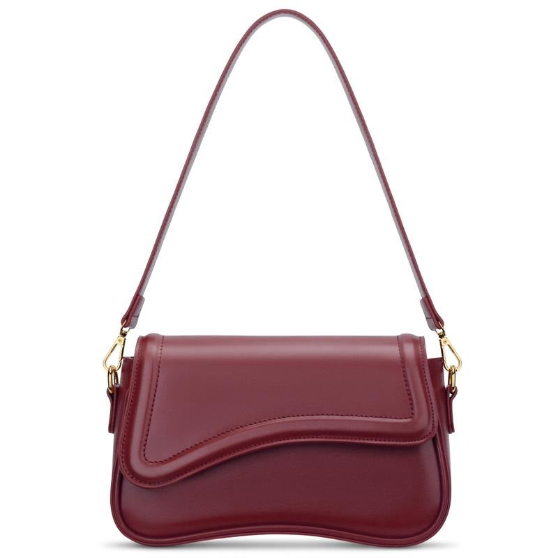 Chic women's shoulder bag with elegant curved flap, crafted from premium vegan leather.
