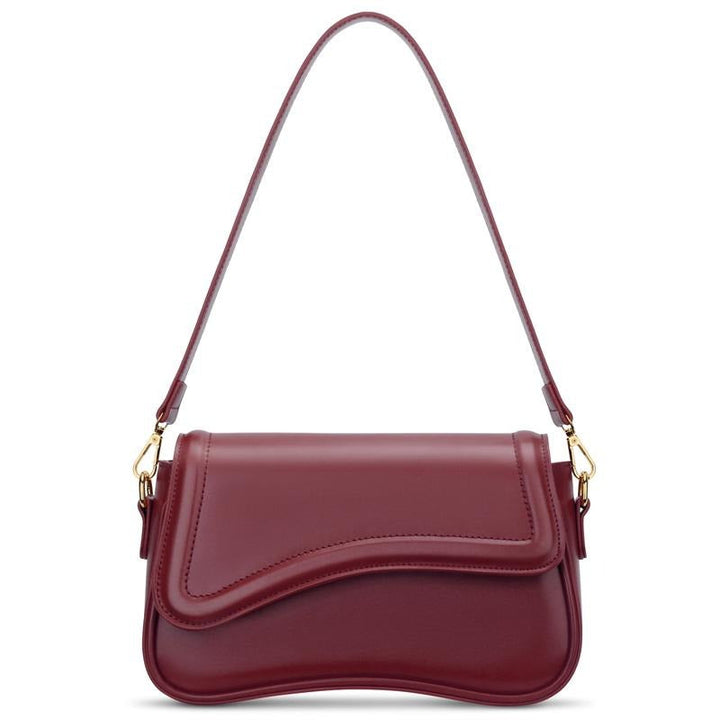Chic women's shoulder bag with elegant curved flap, crafted from premium vegan leather.