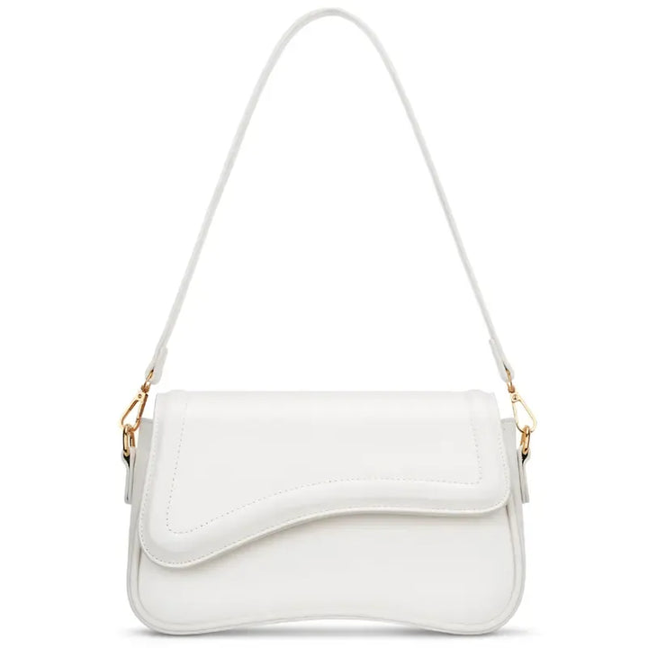 Minimalist women's shoulder bag featuring a stylish curved flap. Elegant vegan leather handbag.