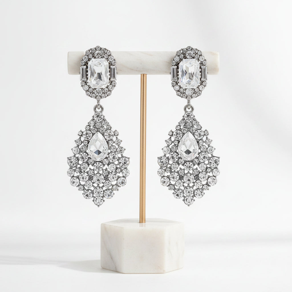 Close-up of dazzling women's rhinestone drop earrings, showcasing intricate sparkle and elegant design.
