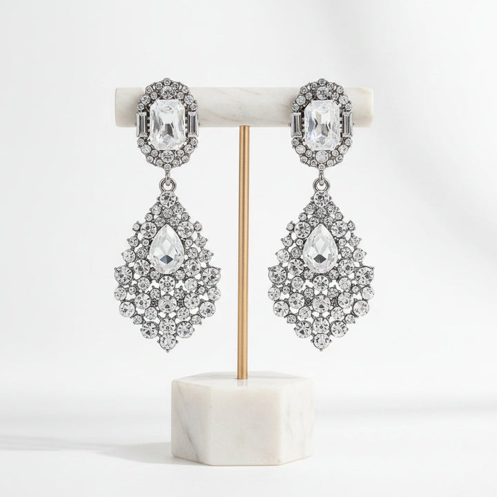 Close-up of dazzling women's rhinestone drop earrings, showcasing intricate sparkle and elegant design.