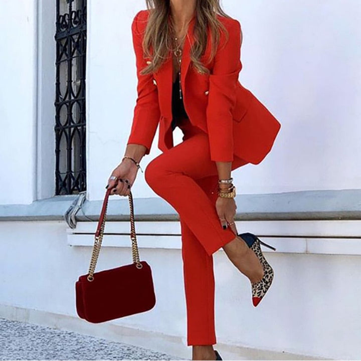 Formal women's suit set: a stylish double-breasted blazer and matching professional tailored pants.