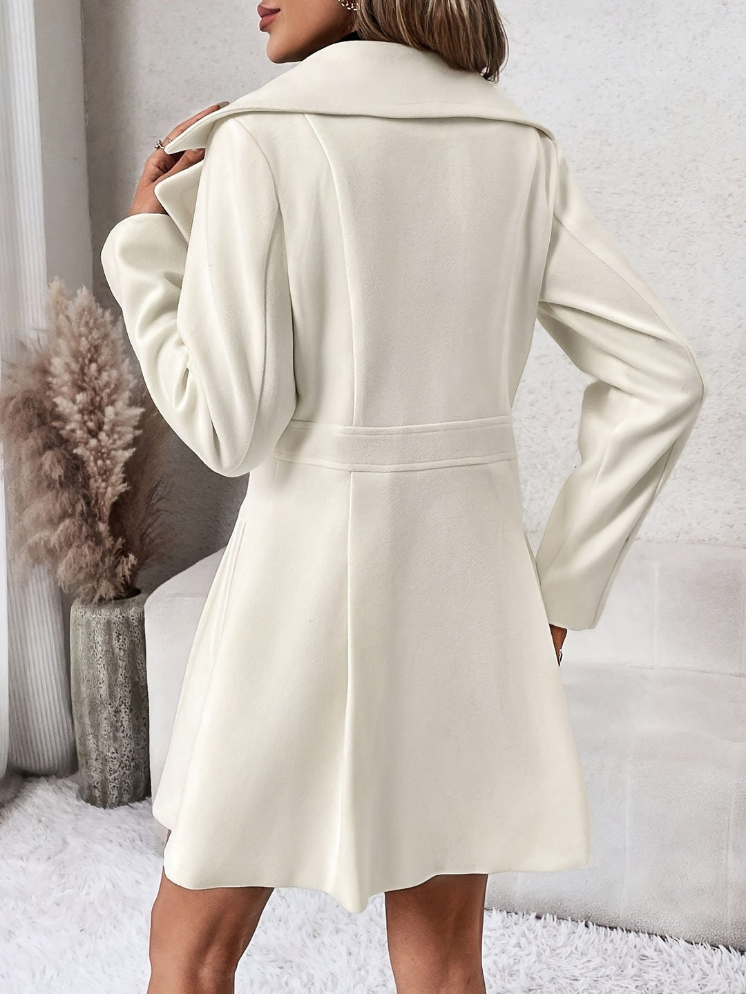 Classic women's flare coat, double-breasted style, ideal elegant outerwear for cold winter days.