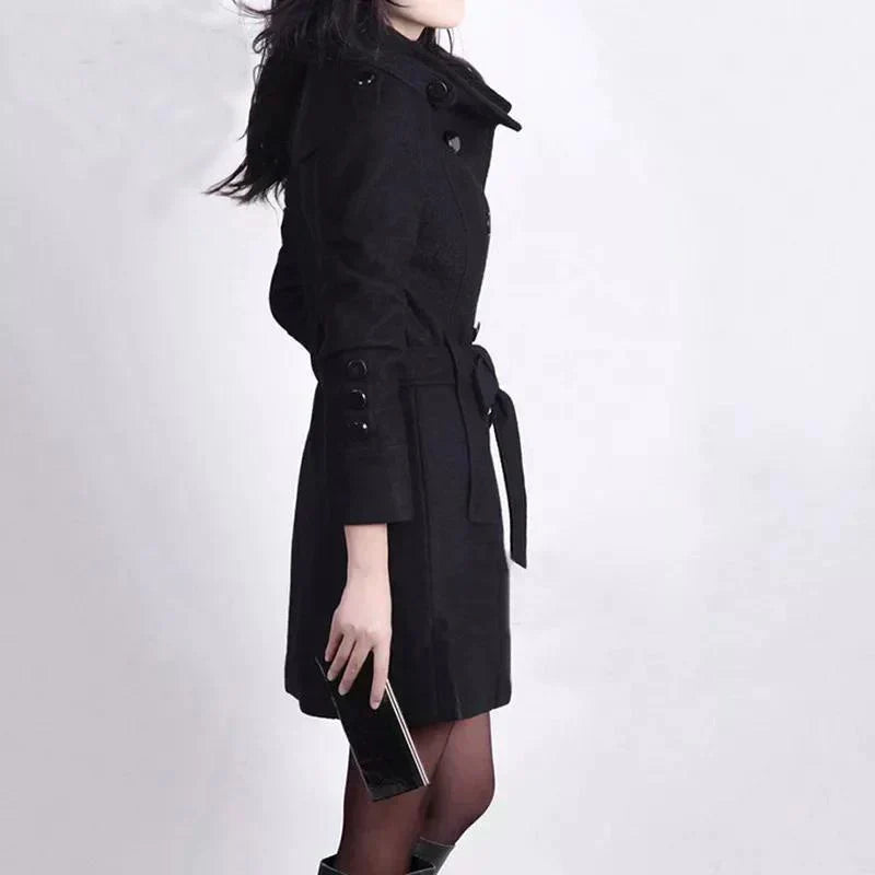 Sophisticated long double-breasted trench coat for women, ideal for business casual or elegant outerwear.
