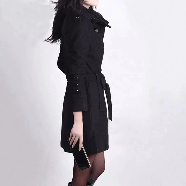 Sophisticated long double-breasted trench coat for women, ideal for business casual or elegant outerwear.