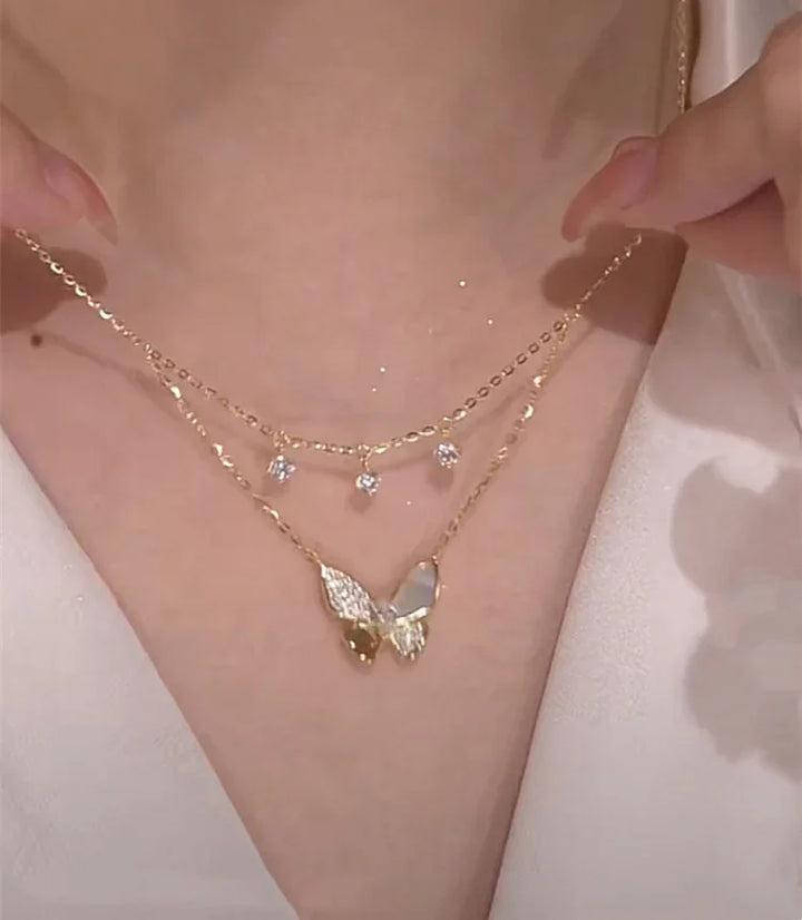 Elegant women's double-layered necklace with sparkling zirconia & iridescent mother-of-pearl butterfly charms. Perfect gift.