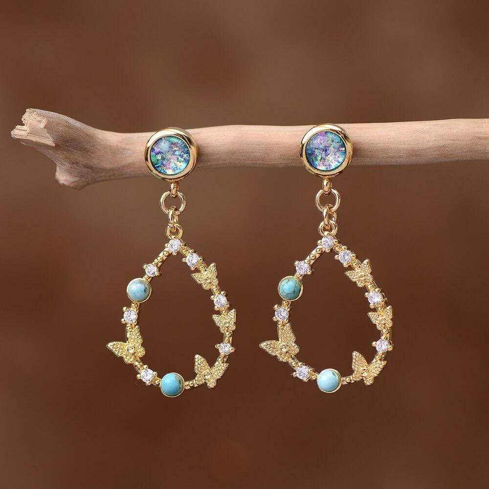 Elegant women's Elemental Opal Raindrop Earrings with shimmering turquoise and zirconium, a unique spiritual gift.
